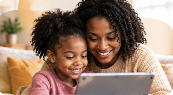 A mother and daughter smiling at a story on a tablet